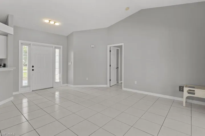 Entrance foyer with lofted ceiling and light tile patterned floors