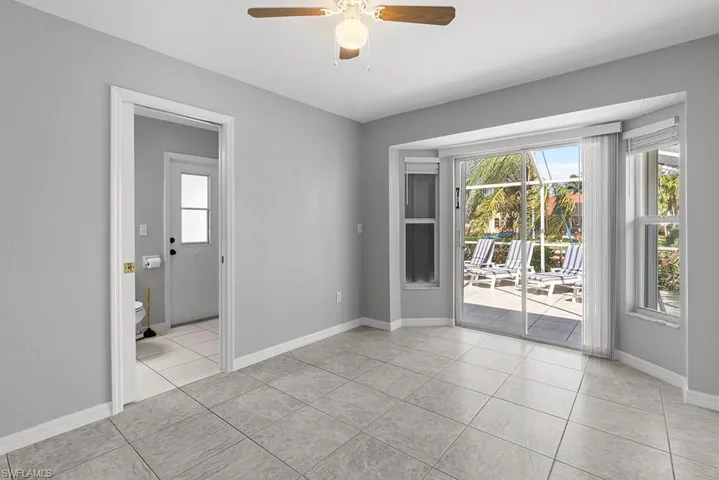 Empty room featuring a ceiling fan and light tile patterned floors