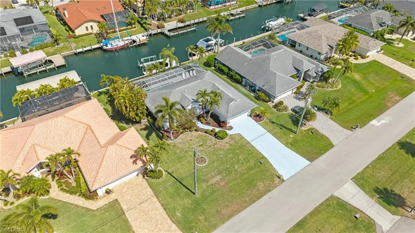 Aerial view of residential area featuring a nearby body of water