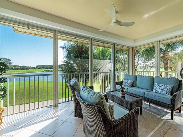 This screened lanai could be considered a sun room with its tiled floor, sitting/TV area and gorgeous views of the lake,  13th tee box and fairway.