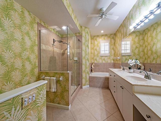 The spacious master bathroom has a large frameless walk-in shower, soaking tub, double sinks and lots of storage.