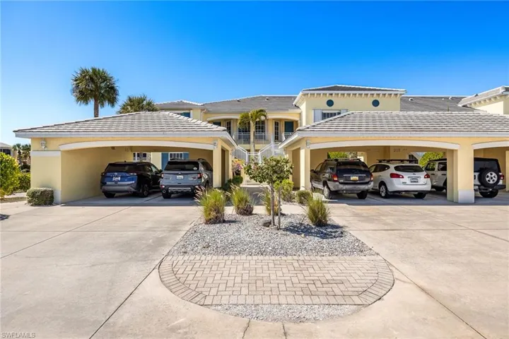 View of front of home with stucco siding and a tile roof