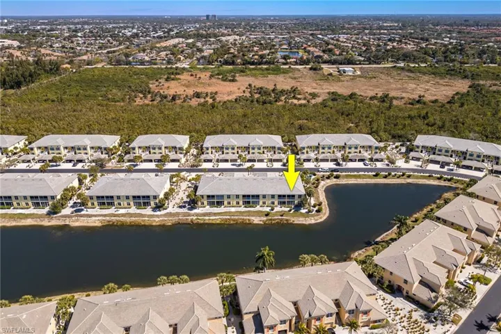 Aerial view of property's location with nearby suburban area and a nearby body of water