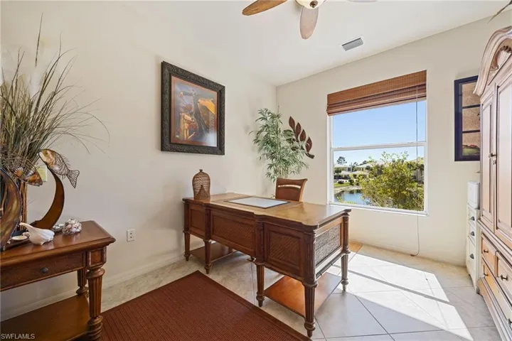 Office featuring a ceiling fan and light tile patterned flooring