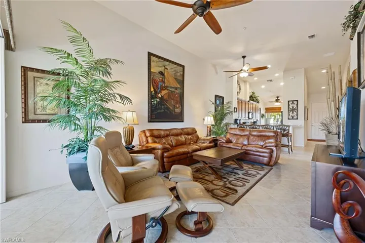 Living area featuring ceiling fan, light tile patterned floors, recessed lighting, and lofted ceiling