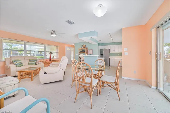 Dining room with plenty of natural light, ceiling fan, and light tile patterned floors