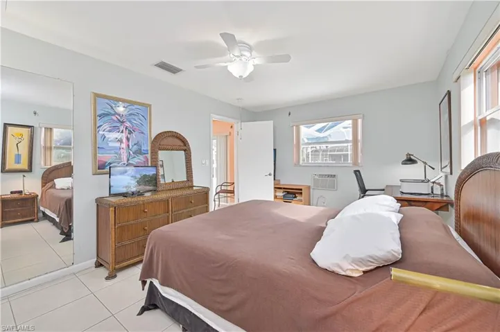 Bedroom featuring light tile patterned flooring and a ceiling fan