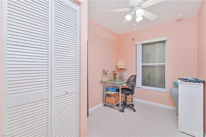 Office space featuring light tile patterned floors and a ceiling fan
