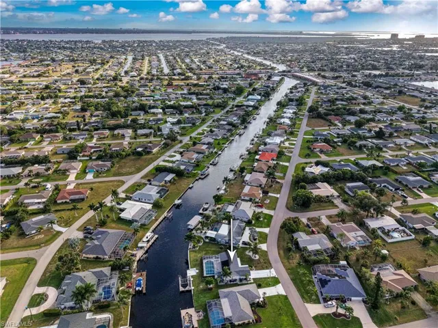 Aerial view of property's location with nearby suburban area and a nearby body of water