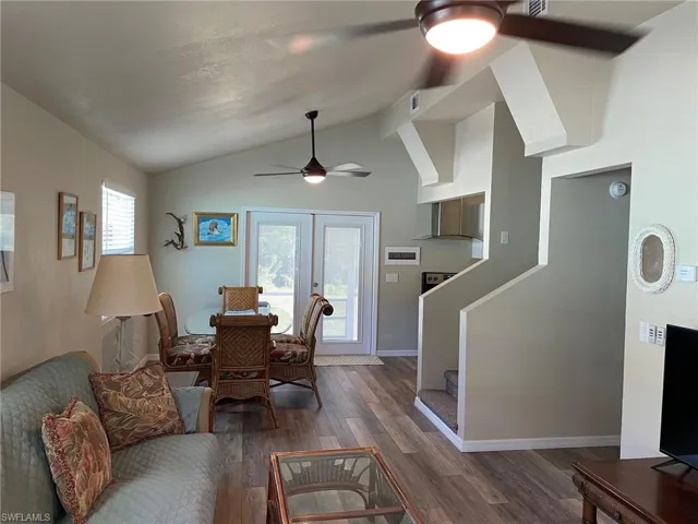 5462-Dining Area with ceiling fan, dark hardwood / wood-style floors, vaulted ceiling, and a healthy amount of sunlight.