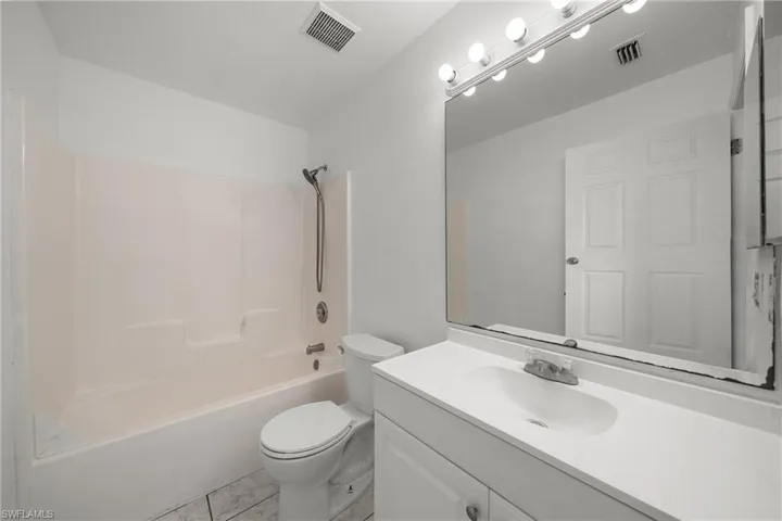Full bathroom featuring vanity, shower / tub combination, and light tile patterned floors