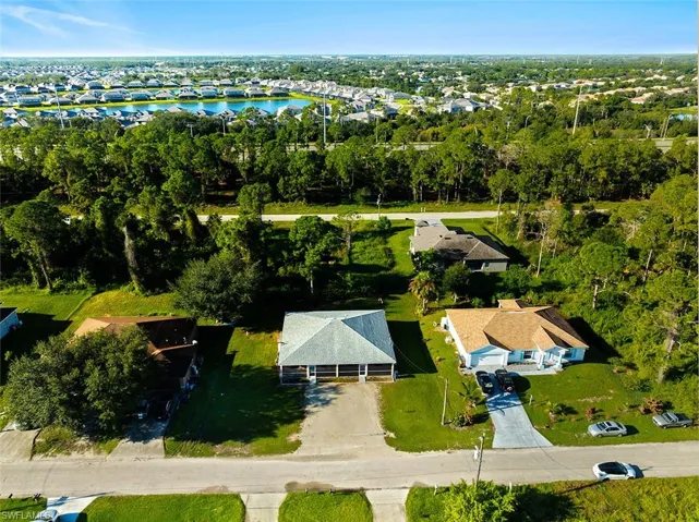 Aerial perspective of suburban area featuring a large body of water