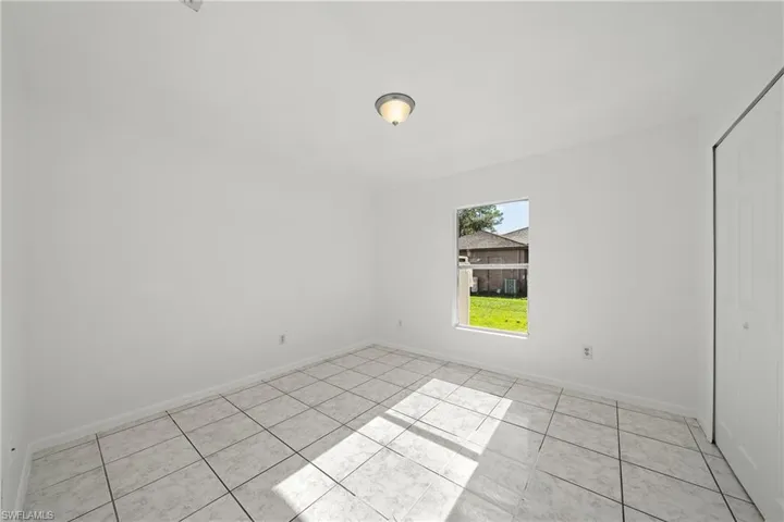 Empty room featuring light tile patterned floors