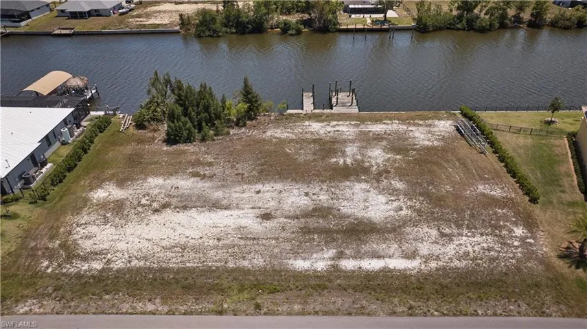 Birds eye view of property with a water view