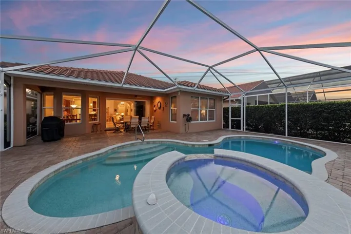 Pool and spa and covered lanai at dusk
