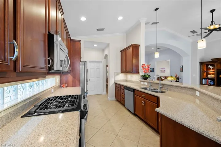 Kitchen with granite count4er tops, tile backsplash, gas range