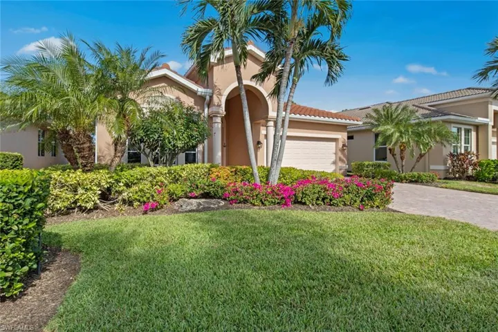 Mediterranean / spanish home with a garage and a front lawn