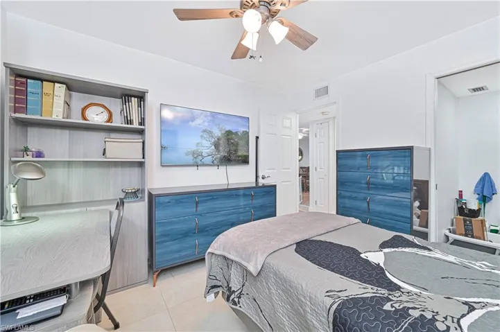 Bedroom with a ceiling fan and light tile patterned floors