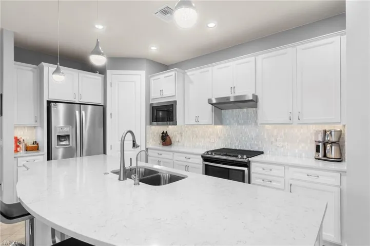 Quartz counters, custom tile backsplash