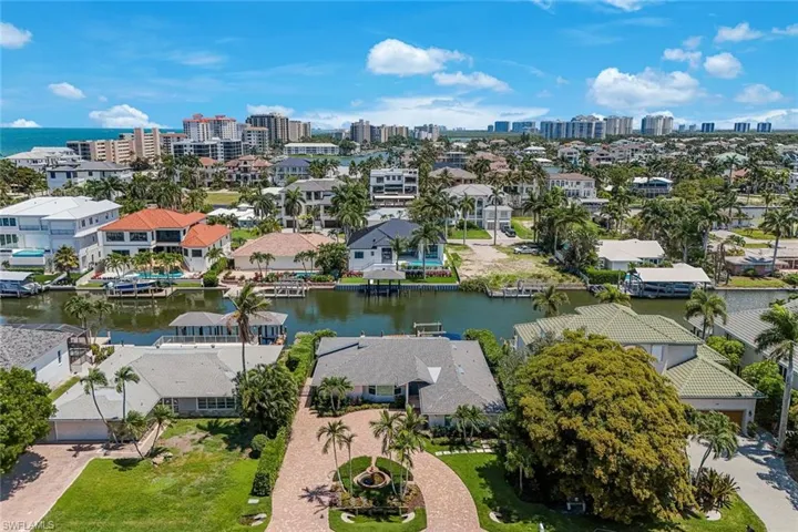Coastal canal-front property featuring a private boat dock