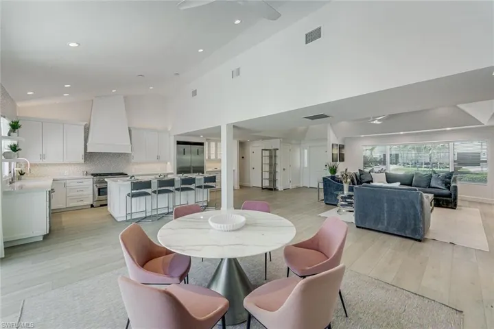 Bright, open-concept interior featuring light wood-finish flooring and recessed lighting