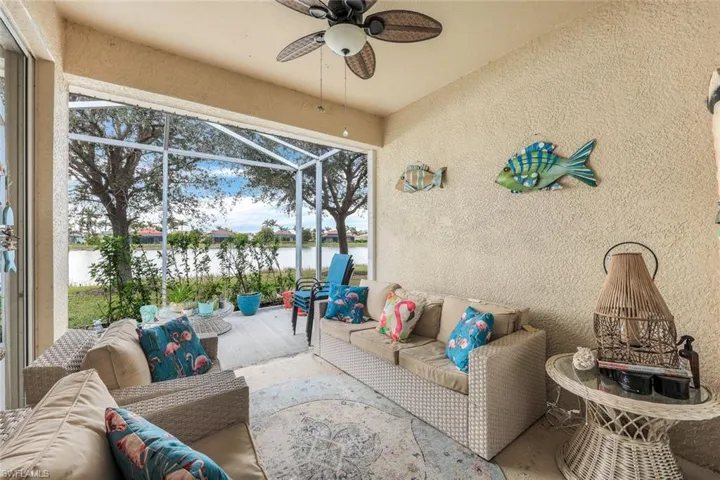 Sunroom with ceiling fan and a water view