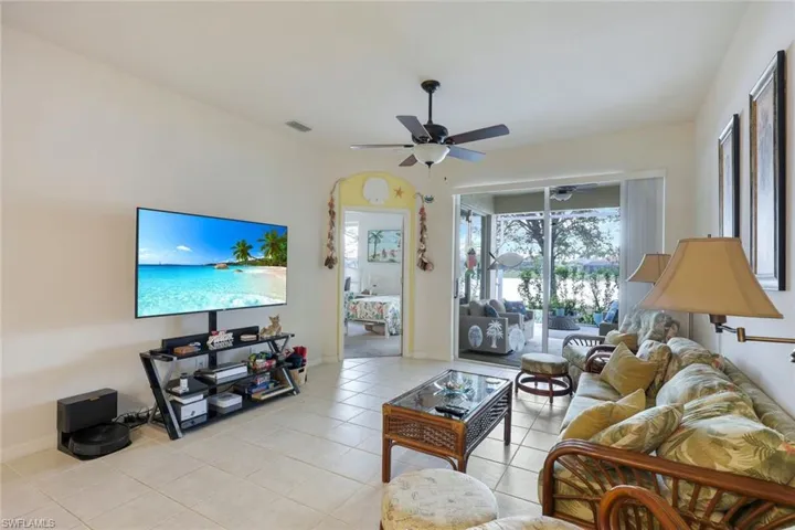 Living room featuring ceiling fan and light tile patterned floors