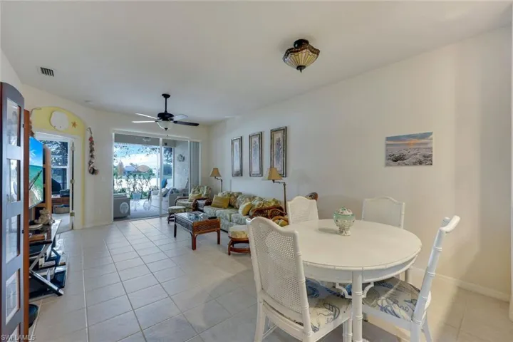 Dining room with ceiling fan and light tile patterned floors