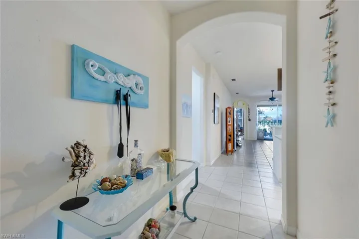 Hall featuring light tile patterned floors