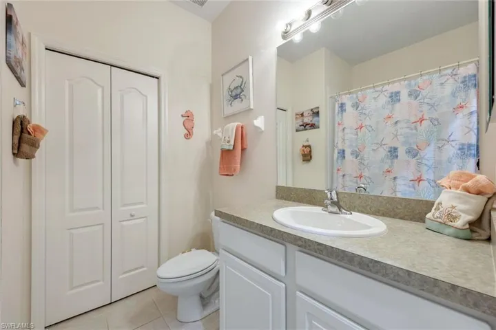 Bathroom featuring toilet, tile patterned floors, and vanity
