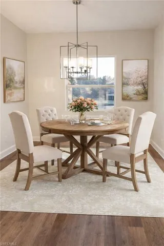 Dining space featuring wood finished floors and hanging lights