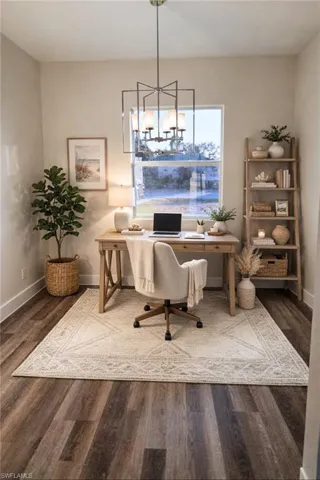 Office area with dark wood-style floors and hanging lights