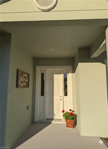 Property entrance featuring stucco siding