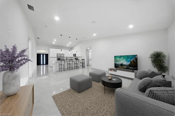 Unfurnished dining area with a chandelier, a high ceiling, and ceiling fan