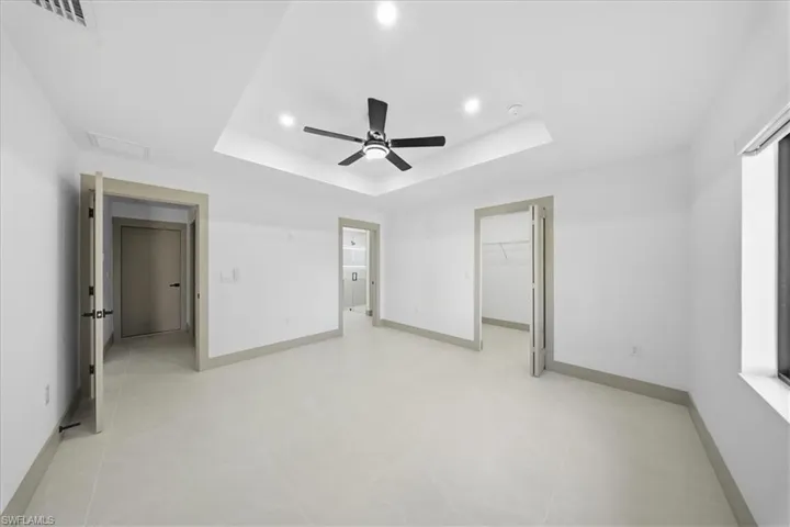 Full bathroom with double vanity, a stall shower, recessed lighting, and light tile patterned flooring