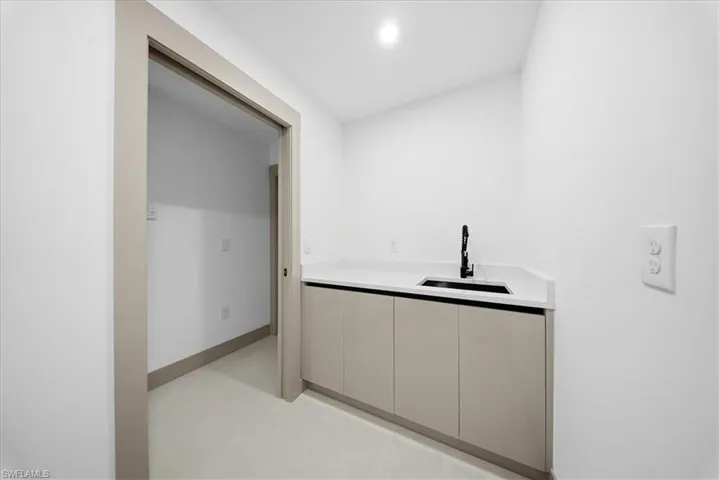 Living room with lofted ceiling and recessed lighting
