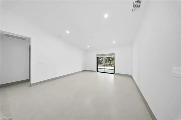 Living room featuring lofted ceiling, recessed lighting, and light tile patterned floors