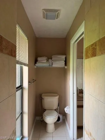 Half bathroom with light tile patterned floors and a textured ceiling