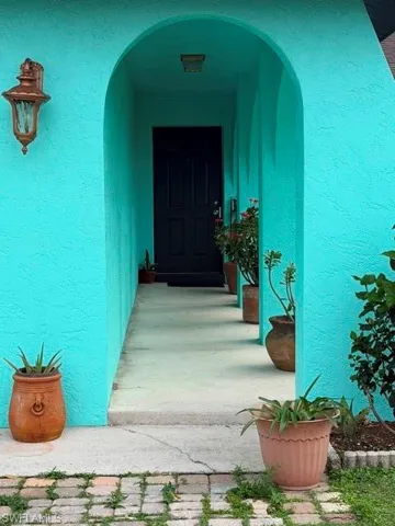 View of exterior entry featuring stucco siding