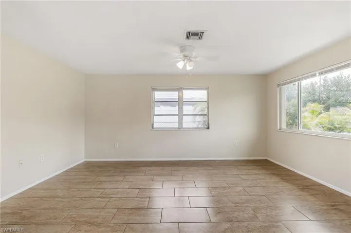 Spare room featuring ceiling fan and baseboards