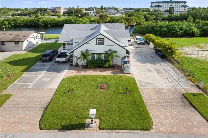 View of front of property featuring a water view and a front yard