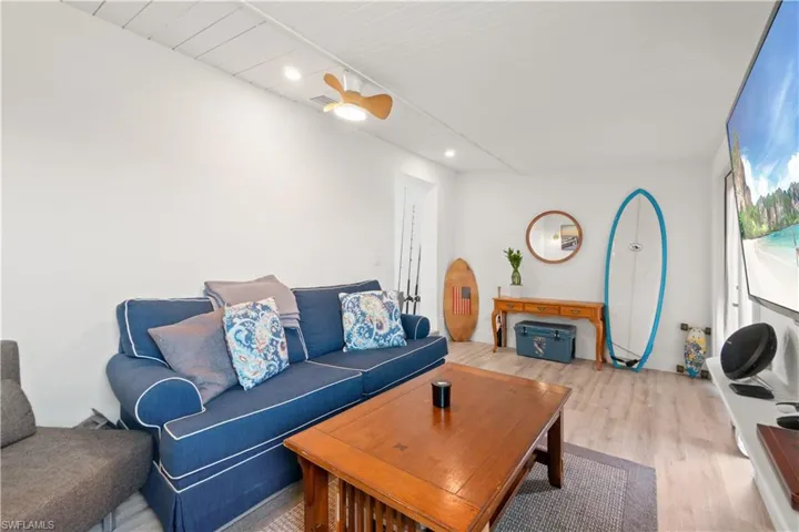 Living room featuring ceiling fan and light hardwood / wood-style flooring