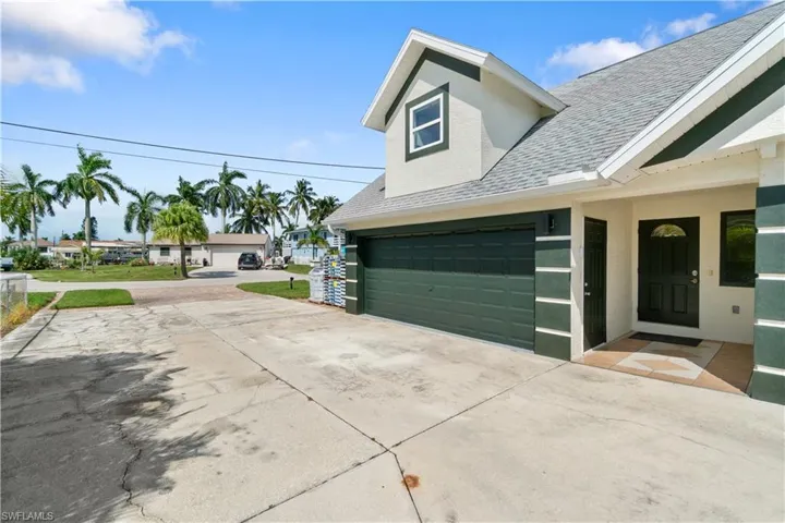 View of side of property with a garage