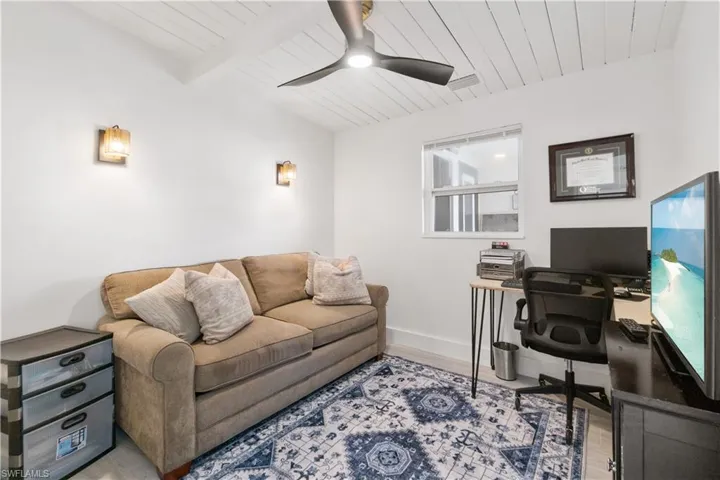 Home office with beamed ceiling, ceiling fan, wooden ceiling, and light wood-type flooring