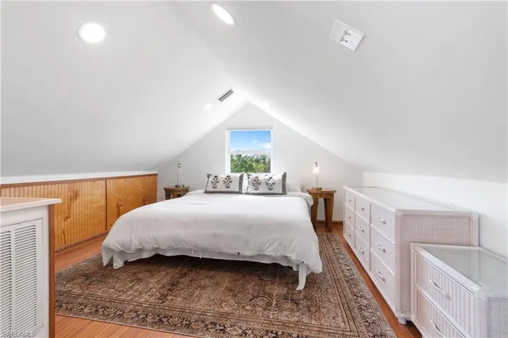 Bedroom featuring lofted ceiling and light hardwood / wood-style flooring
