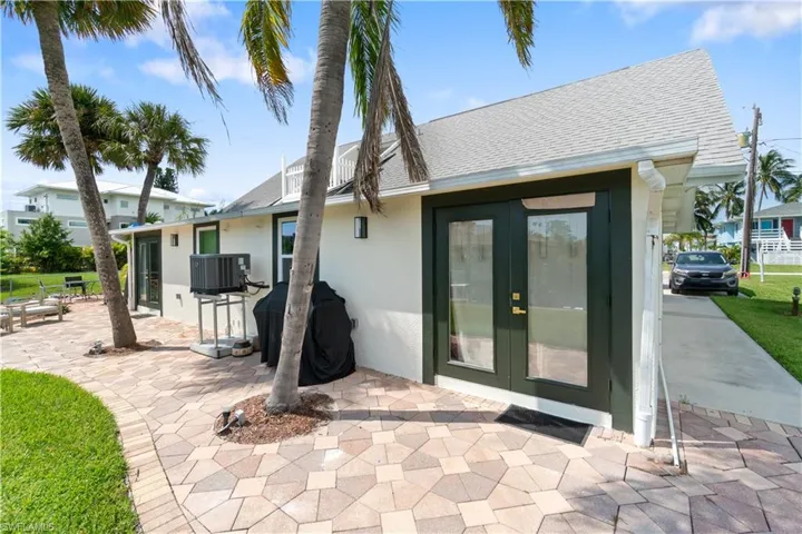 Back of property featuring a patio, central AC, and french doors
