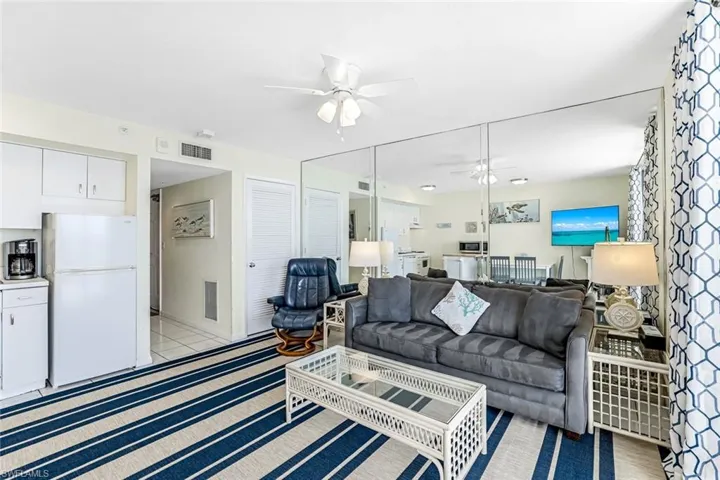 Living room featuring a ceiling fan and baseboards