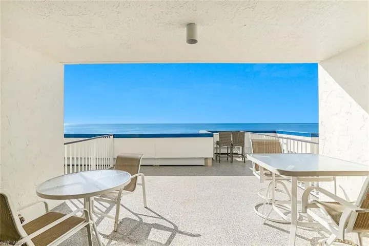Balcony with a water view and outdoor dining space