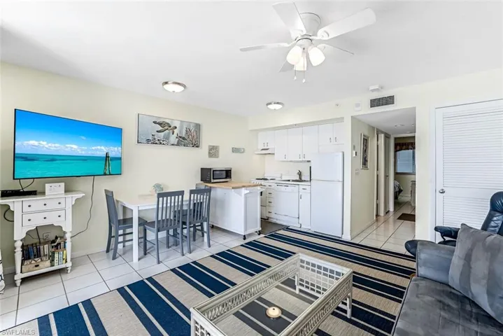 Living room featuring ceiling fan and light tile patterned floors