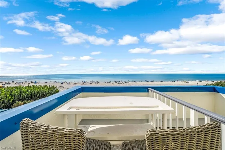 Balcony with view of water and beach